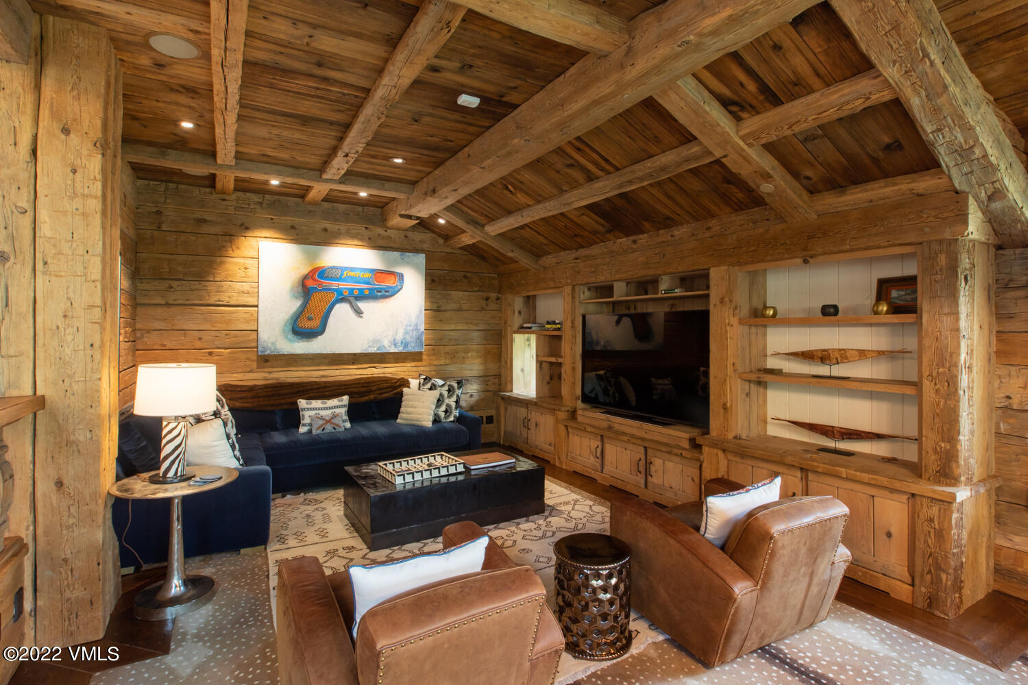 97 Rockledge Road Vail, CO 81657 - Photo 7 of 35 a projector room with fireplace furniture and a flat screen tv