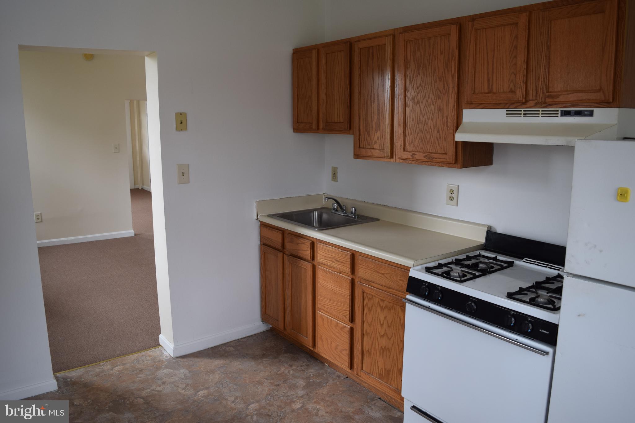 3810 Chesley Avenue Baltimore, MD 21206 - Photo 11 of 14 a kitchen with wooden cabinets and a stove top oven