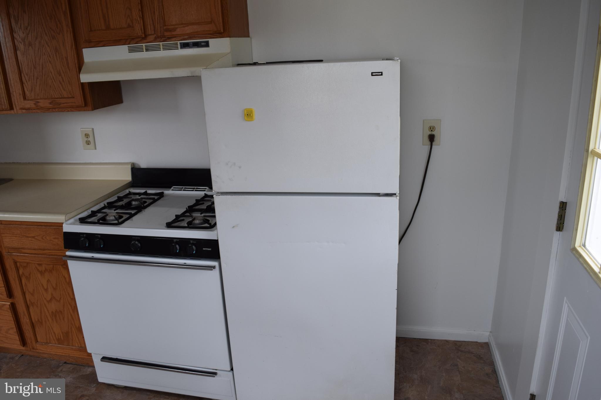 3810 Chesley Avenue Baltimore, MD 21206 - Photo 12 of 14 a white refrigerator freezer and a stove sitting inside of a kitchen