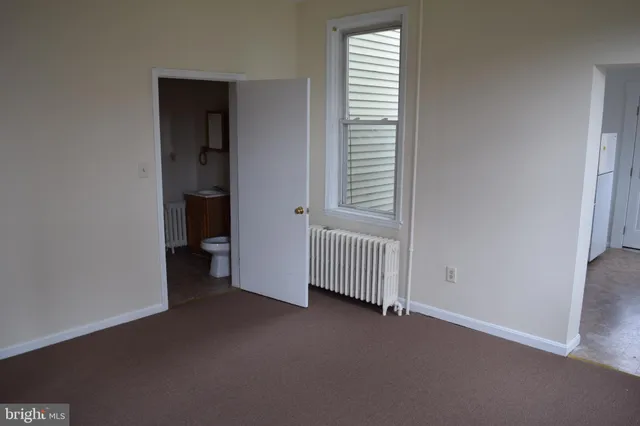 a view of a room with a window and a kitchen
