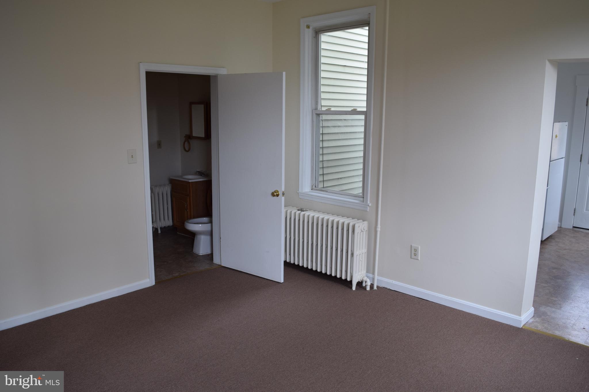 3810 Chesley Avenue Baltimore, MD 21206 - Photo 4 of 14 a view of a room with a window and a kitchen