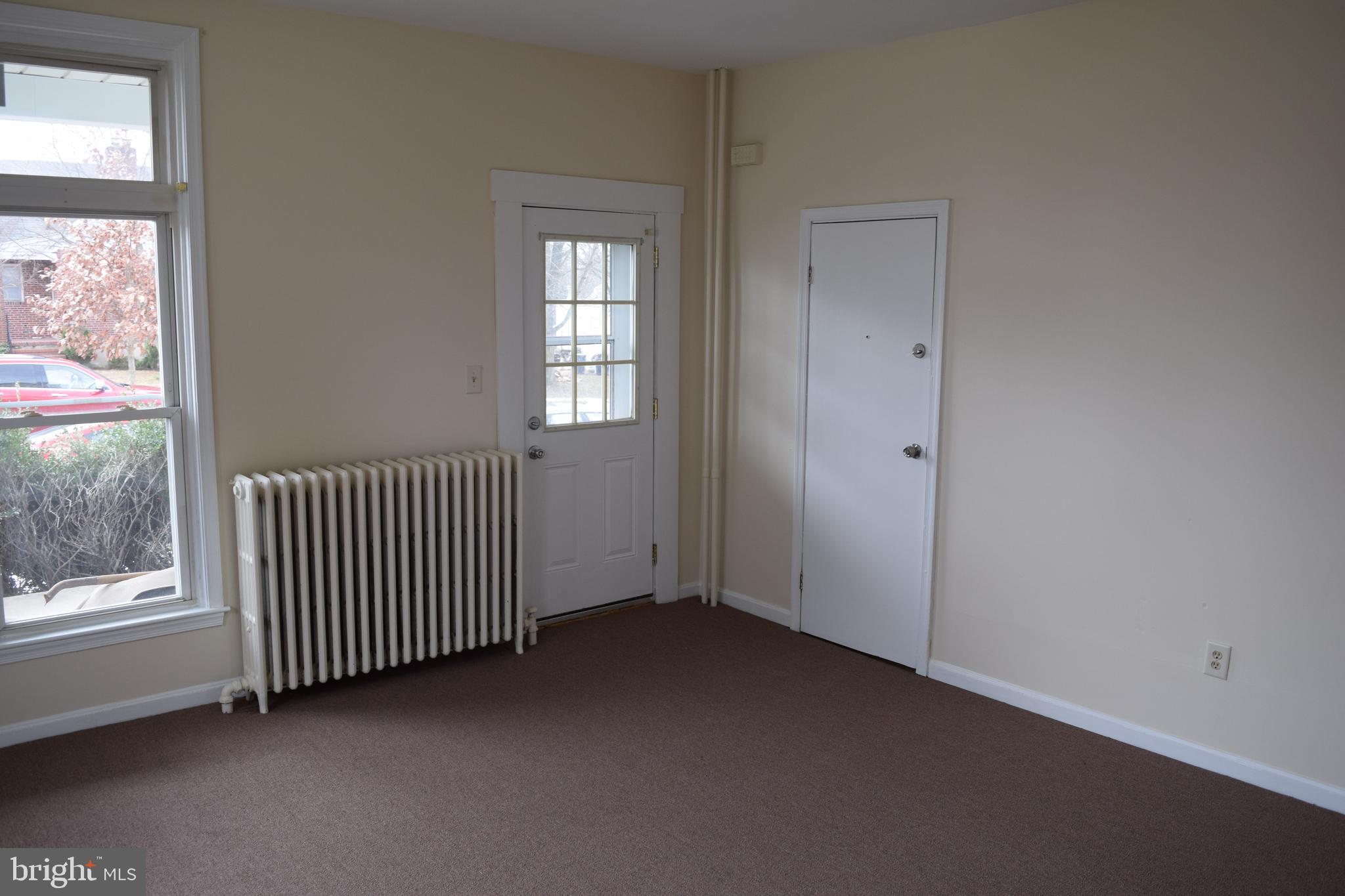 3810 Chesley Avenue Baltimore, MD 21206 - Photo 6 of 14 an empty room with windows