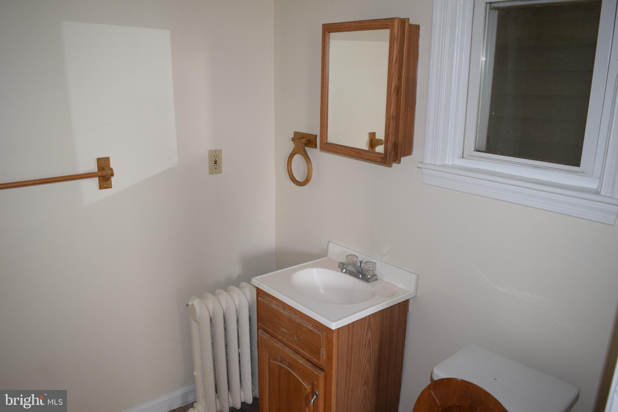 3810 Chesley Avenue Baltimore, MD 21206 - Photo 9 of 14 a bathroom with a sink and mirror