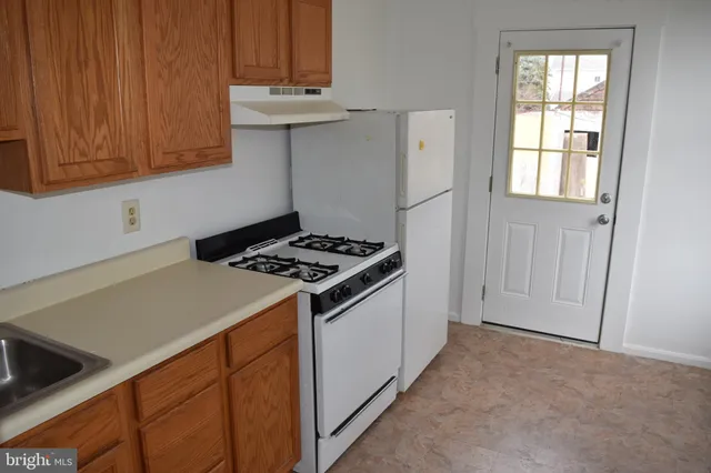 a kitchen with stainless steel appliances granite countertop a stove and a refrigerator