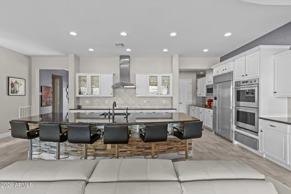 a living room with furniture a dining table and a chandelier