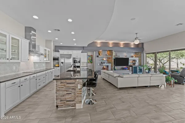 a kitchen with stainless steel appliances kitchen island granite countertop a sink and cabinets