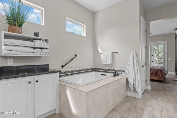 a view of large white house with a large tree