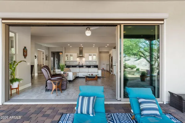 an aerial view of a house with a swimming pool and outdoor seating