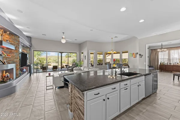 a kitchen with stainless steel appliances granite countertop a sink and a refrigerator