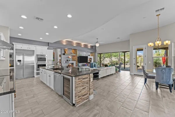 a kitchen with stainless steel appliances kitchen island granite countertop a sink and cabinets