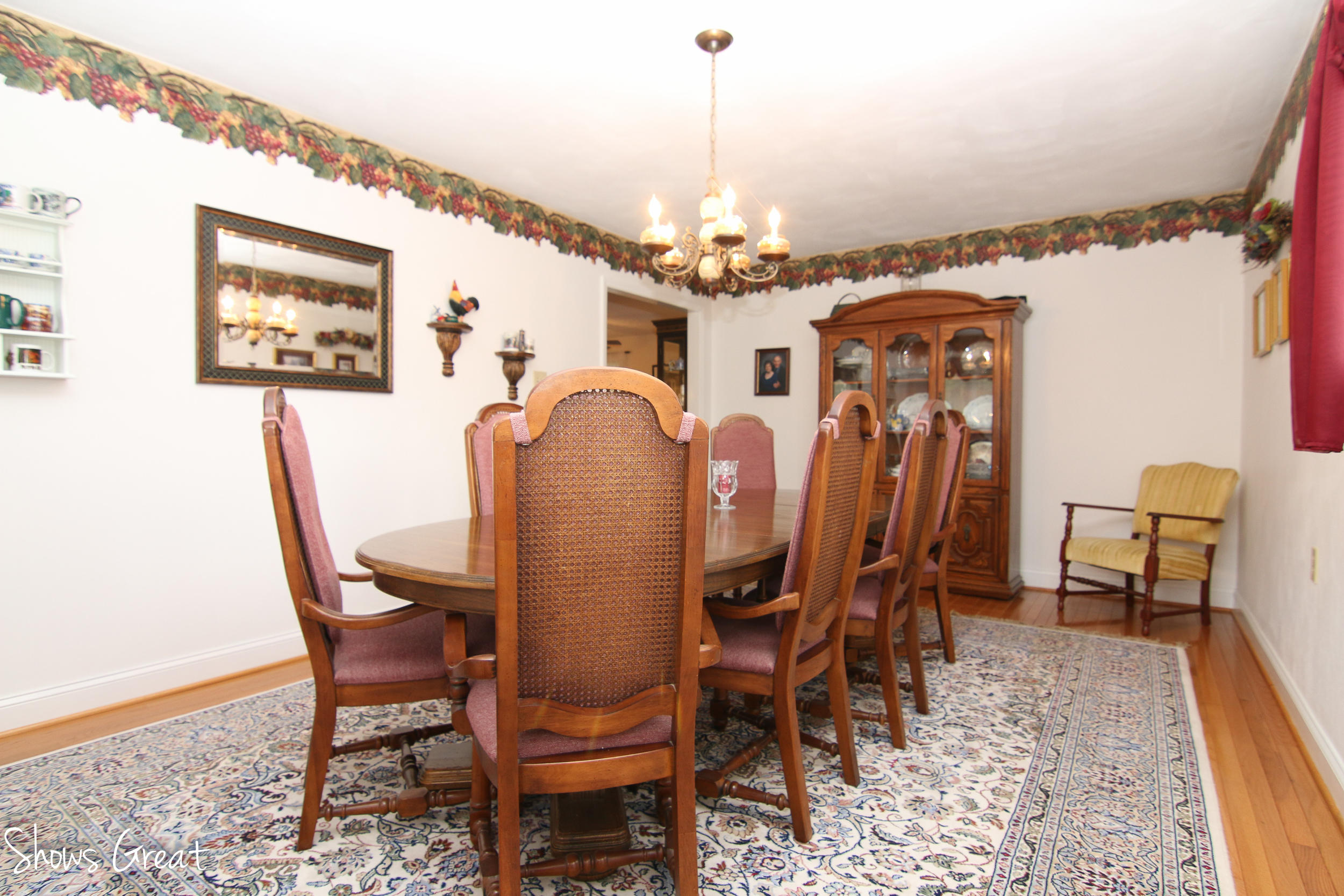 3315 Retreat Road Boones Mill, VA 24065 - Photo 30 of 57 a dining room with furniture a chandelier and wooden floor