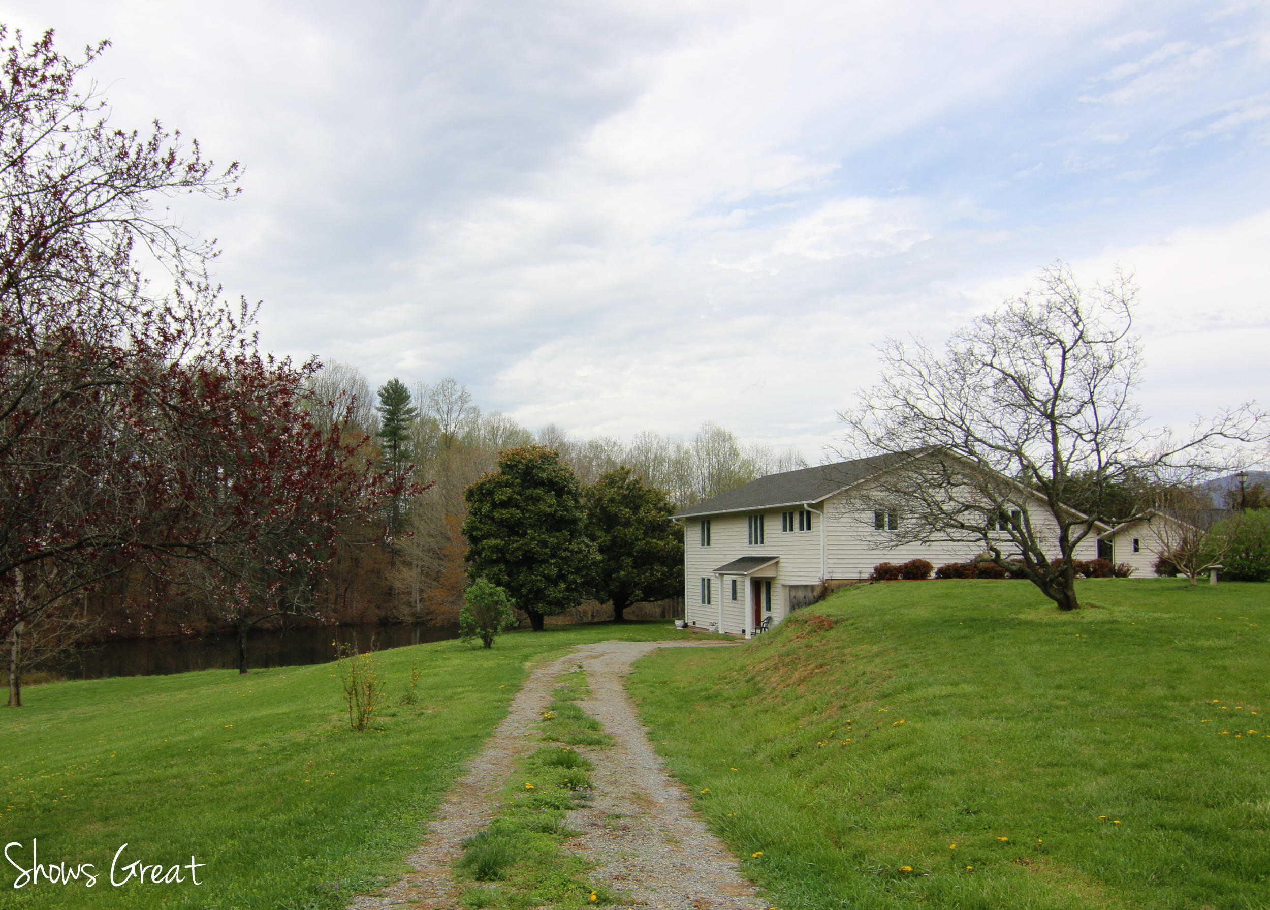 3315 Retreat Road Boones Mill, VA 24065 - Photo 56 of 57 a view of a white house next to a yard with big trees