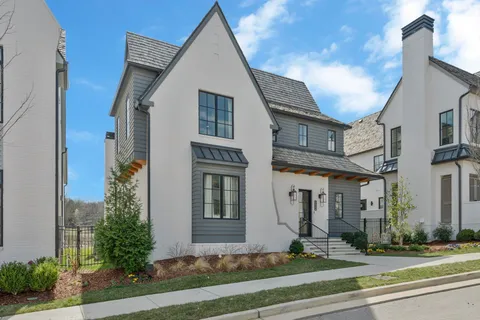 a view of a white building among the street and tree