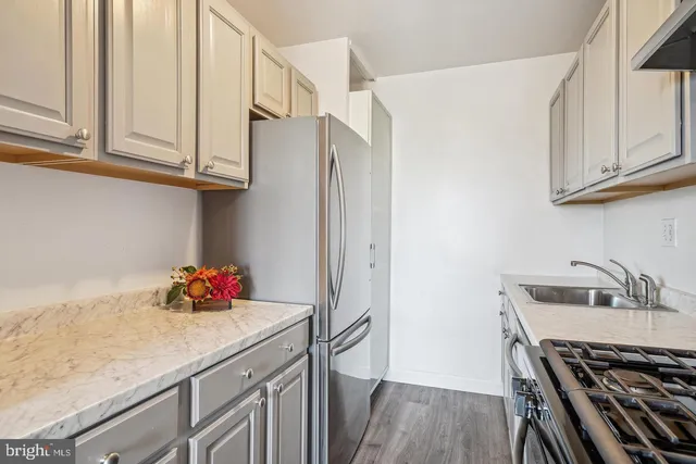 a kitchen with stainless steel appliances a sink and cabinets