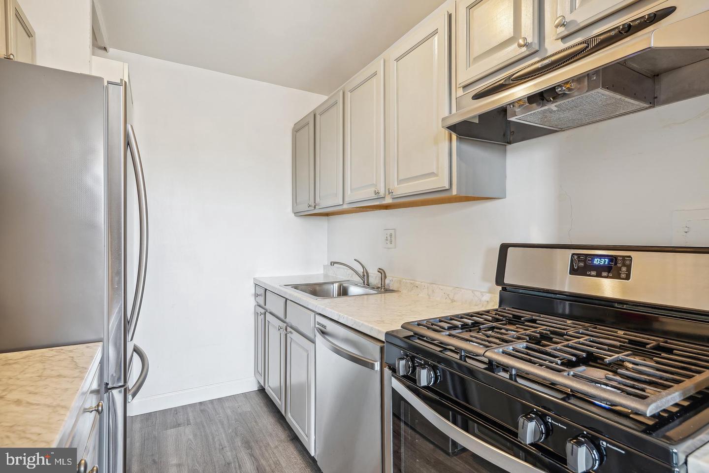 1300 South Arlington Ridge Road, Unit 705 Arlington, VA 22202 - Photo 14 of 25 a kitchen with stainless steel appliances granite countertop a stove and a refrigerator
