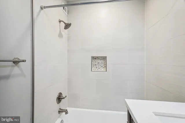 a bathroom with a shower and a bath tub