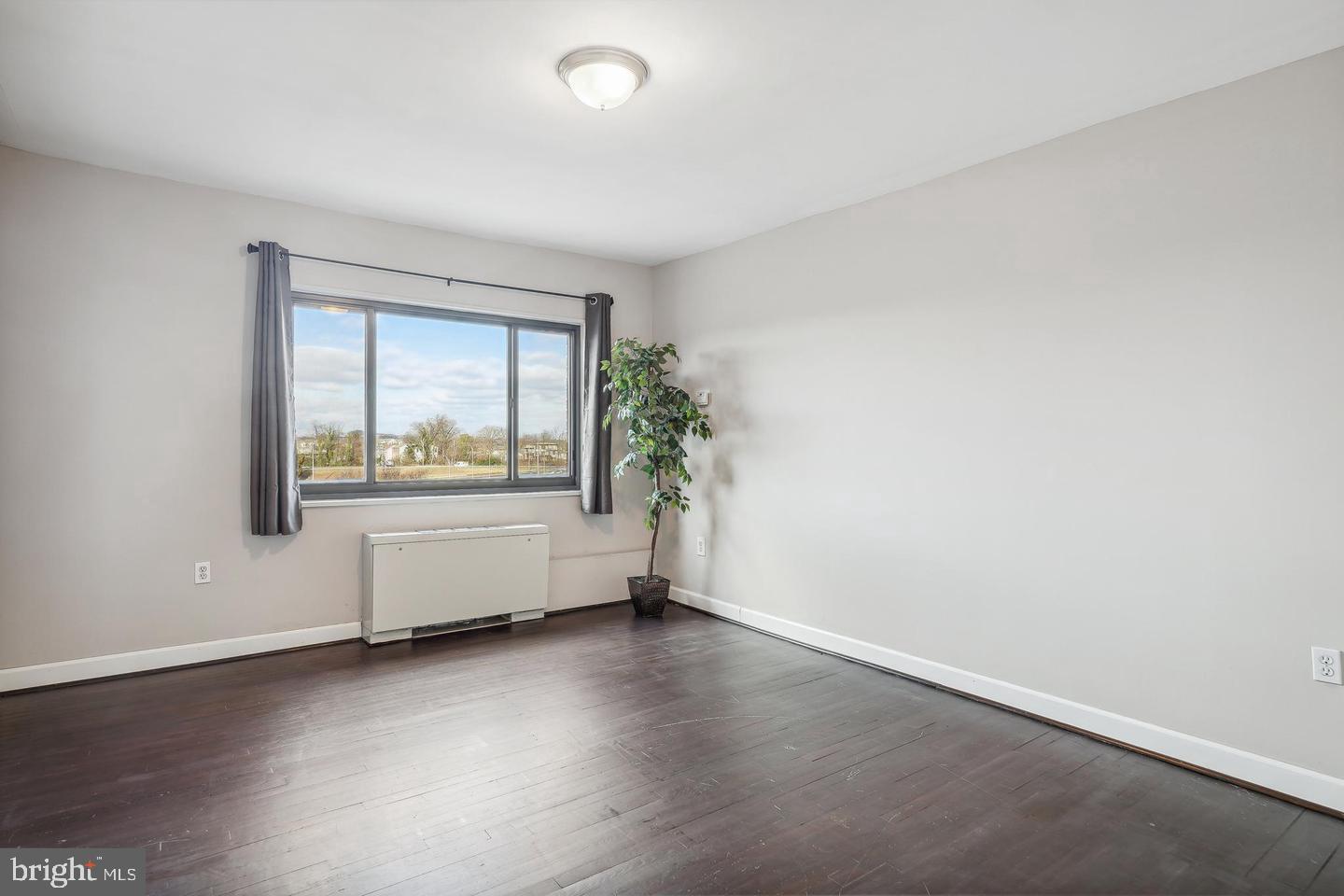1300 South Arlington Ridge Road, Unit 705 Arlington, VA 22202 - Photo 20 of 25 an empty room with wooden floor and windows