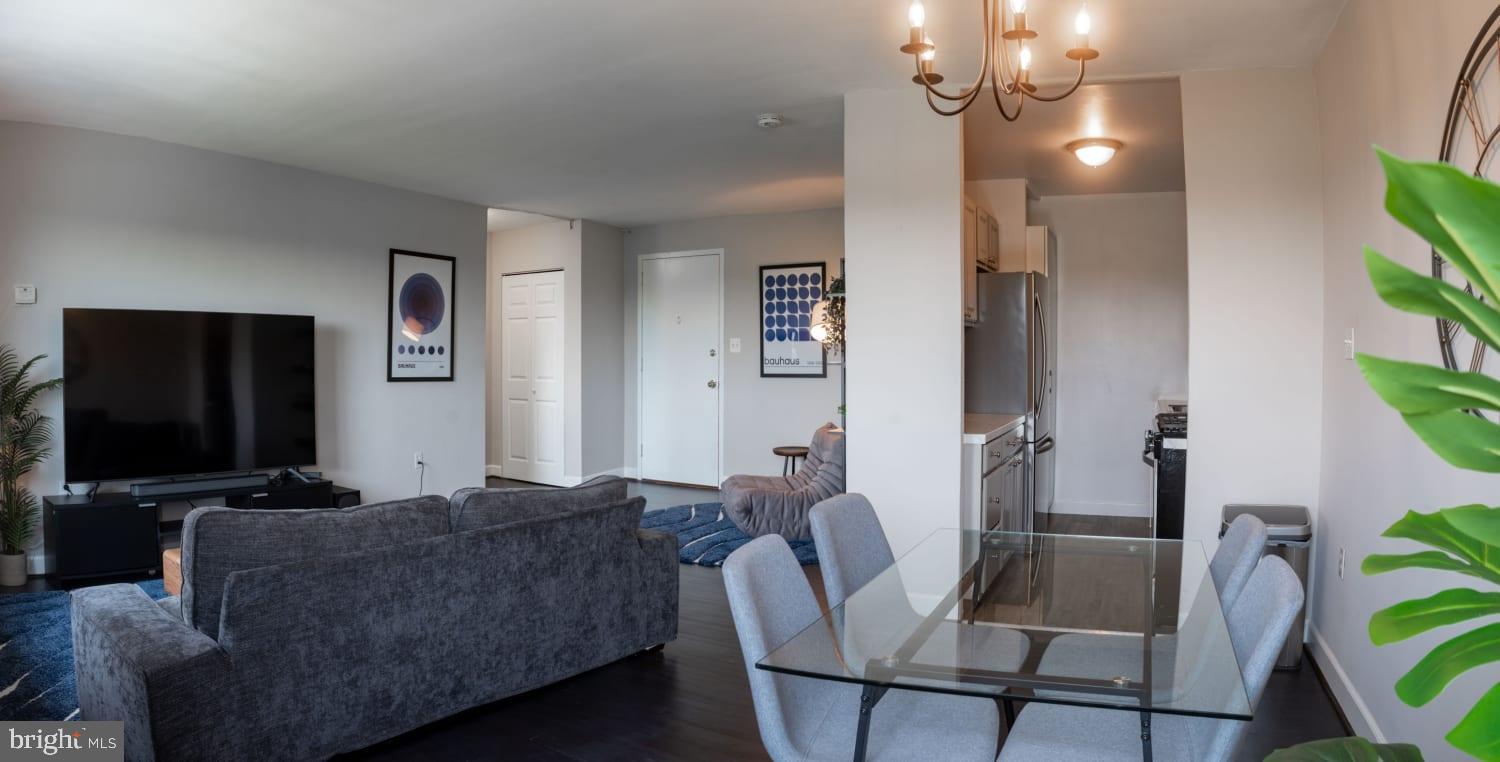 1300 South Arlington Ridge Road, Unit 705 Arlington, VA 22202 - Photo 5 of 25 a living room with furniture and a flat screen tv
