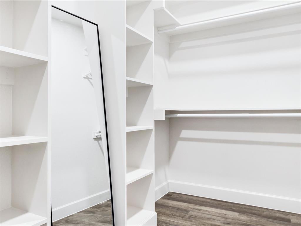 4705 Point La Vista Road Malakoff, TX 75148 - Photo 7 of 40 Built-in shelving, hanging rods, full-length mirror, wood-finish flooring, and white trim