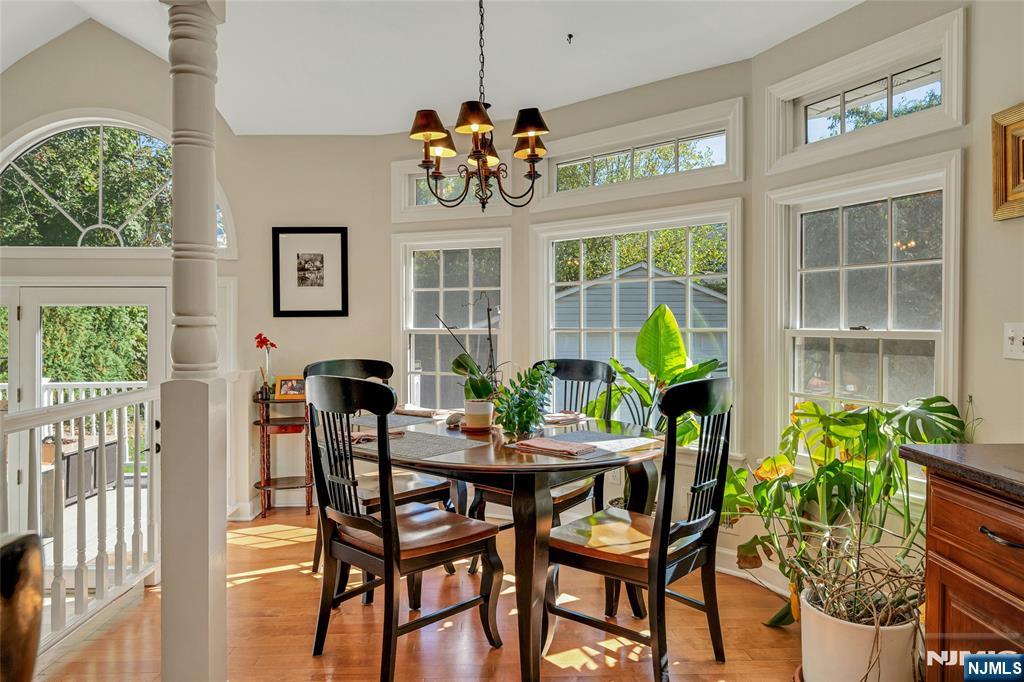66 Smull Avenue Caldwell, NJ 07006 - Photo 13 of 32 a dining room with furniture a potted plant and a chandelier