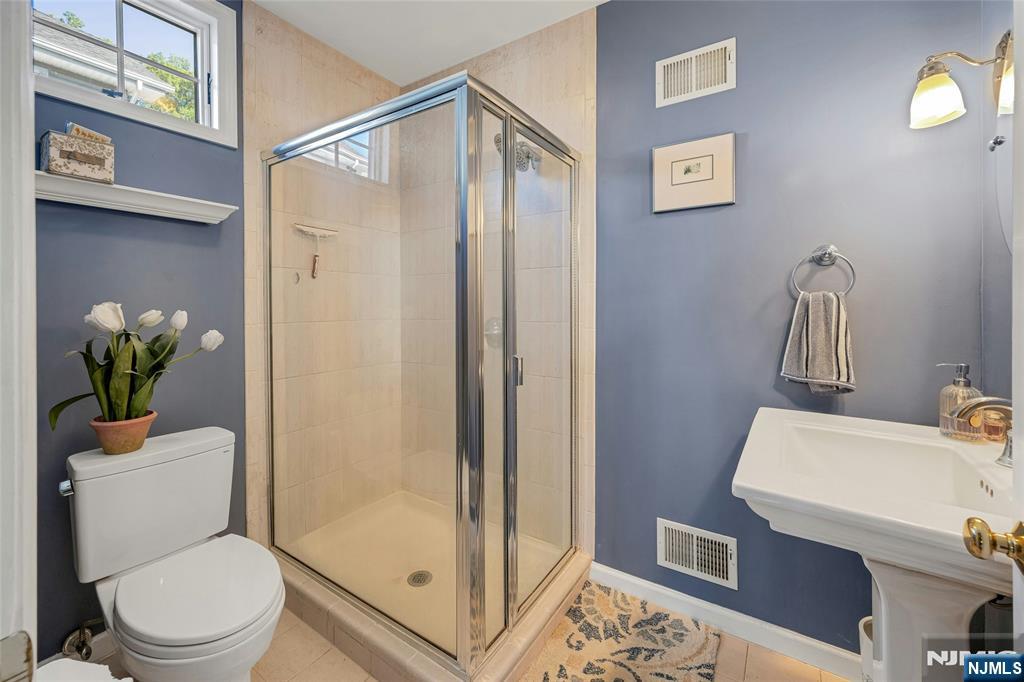 66 Smull Avenue Caldwell, NJ 07006 - Photo 15 of 32 a bathroom with a sink a toilet and shower