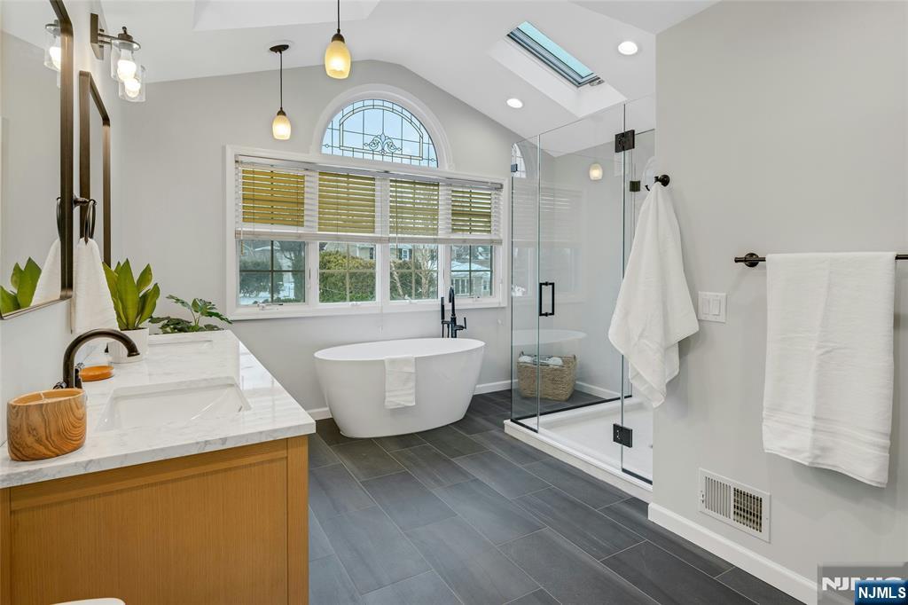 66 Smull Avenue Caldwell, NJ 07006 - Photo 21 of 32 a bathroom with a granite countertop sink and a large mirror
