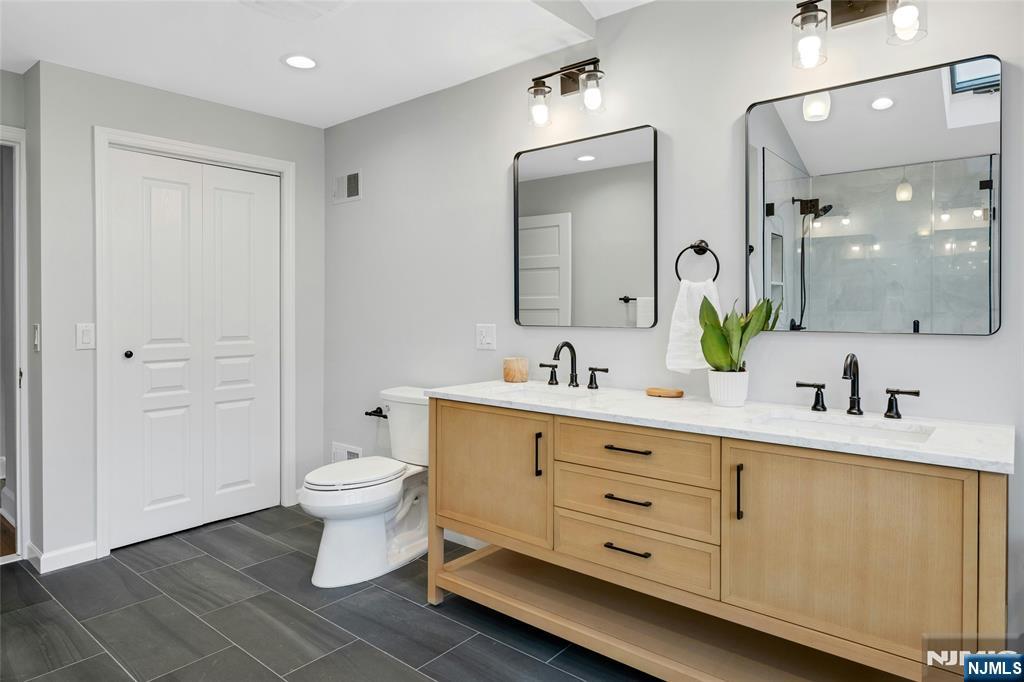 66 Smull Avenue Caldwell, NJ 07006 - Photo 23 of 32 a bathroom with a double vanity sink mirror and toilet
