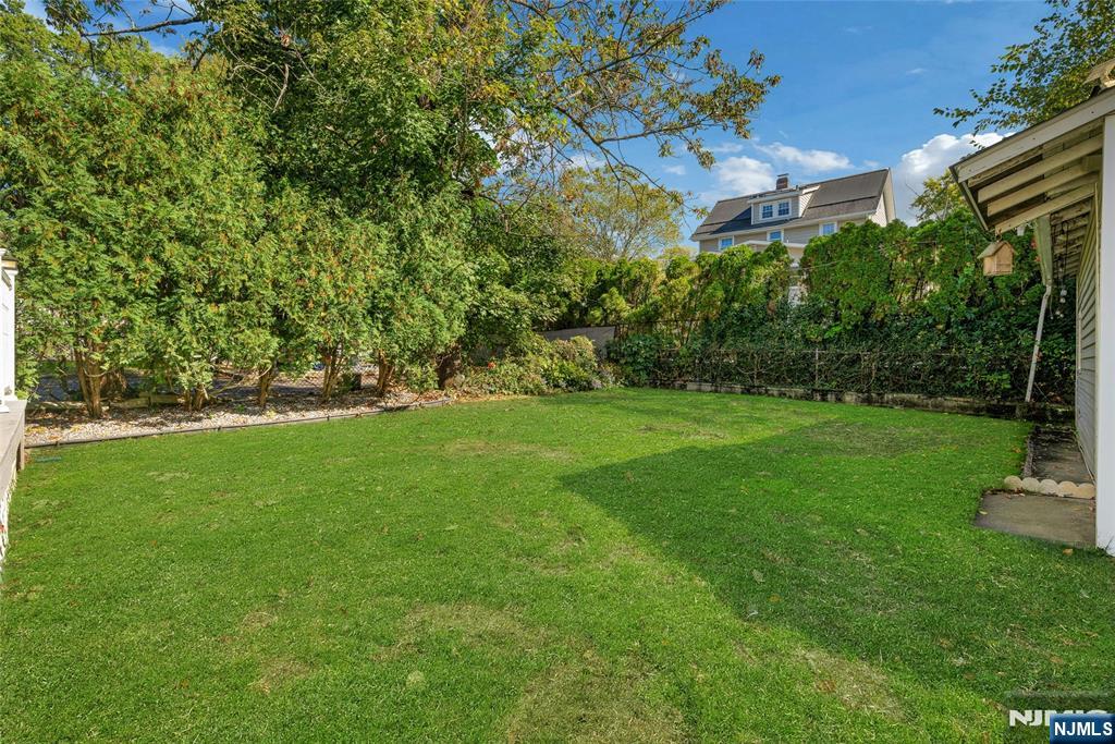 66 Smull Avenue Caldwell, NJ 07006 - Photo 31 of 32 a view of a garden with a building in the background