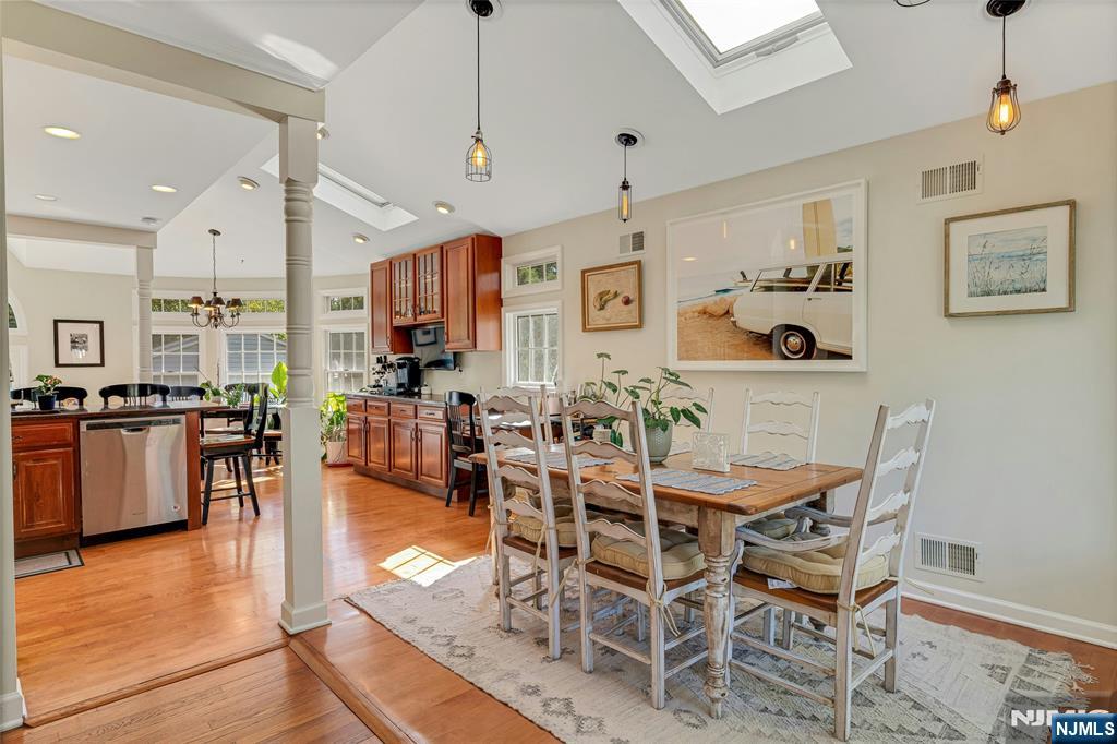 66 Smull Avenue Caldwell, NJ 07006 - Photo 8 of 32 a view of a dining room and livingroom with furniture wooden floor a chandelier