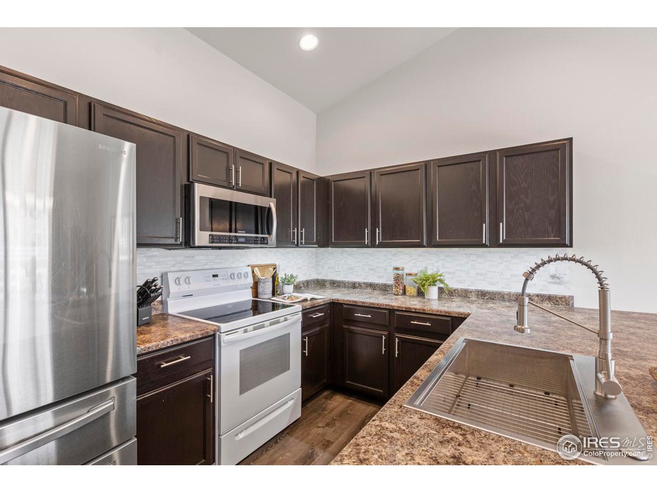 1010 Axis Drive Severance, CO 80550 - Photo 10 of 33 a kitchen with a sink cabinets and stainless steel appliances