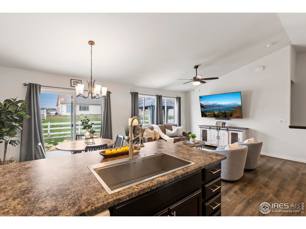 1010 Axis Drive Severance, CO 80550 - Photo 12 of 33 a living room with furniture a flat screen tv and a large window