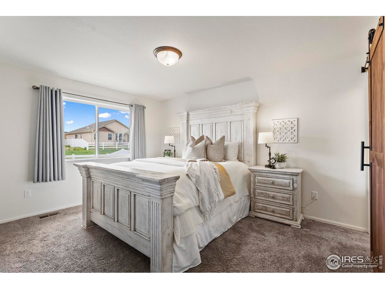 1010 Axis Drive Severance, CO 80550 - Photo 14 of 33 a bedroom with a bed and a large window