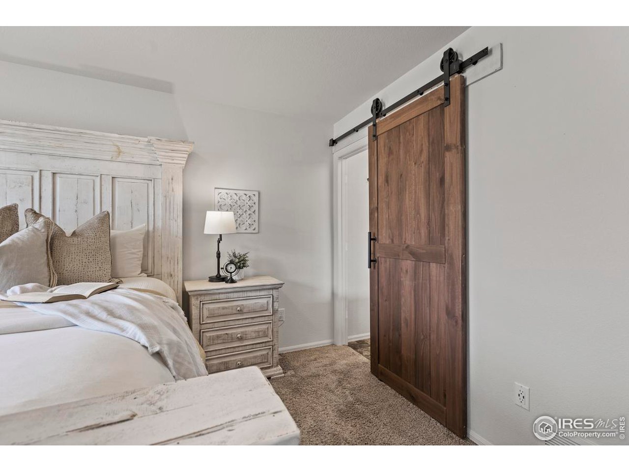 1010 Axis Drive Severance, CO 80550 - Photo 16 of 33 a bedroom with a bed and a dresser