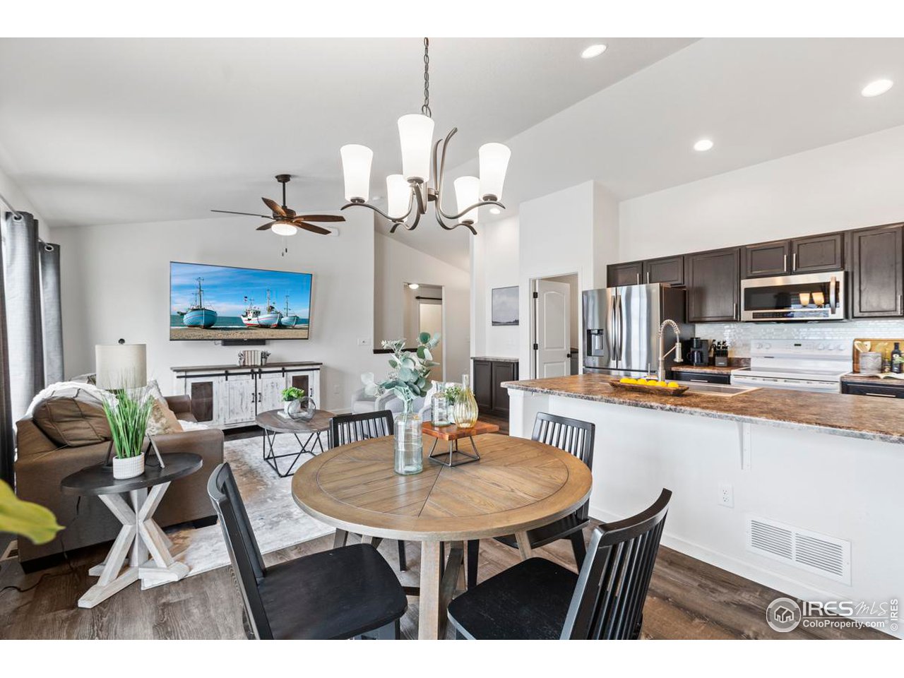 1010 Axis Drive Severance, CO 80550 - Photo 4 of 33 a view of dining room and kitchen island with furniture