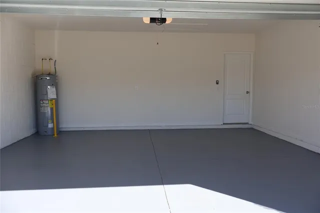a kitchen with kitchen island granite countertop a sink and a refrigerator