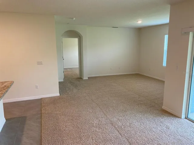 an empty room with a mirror and a sink