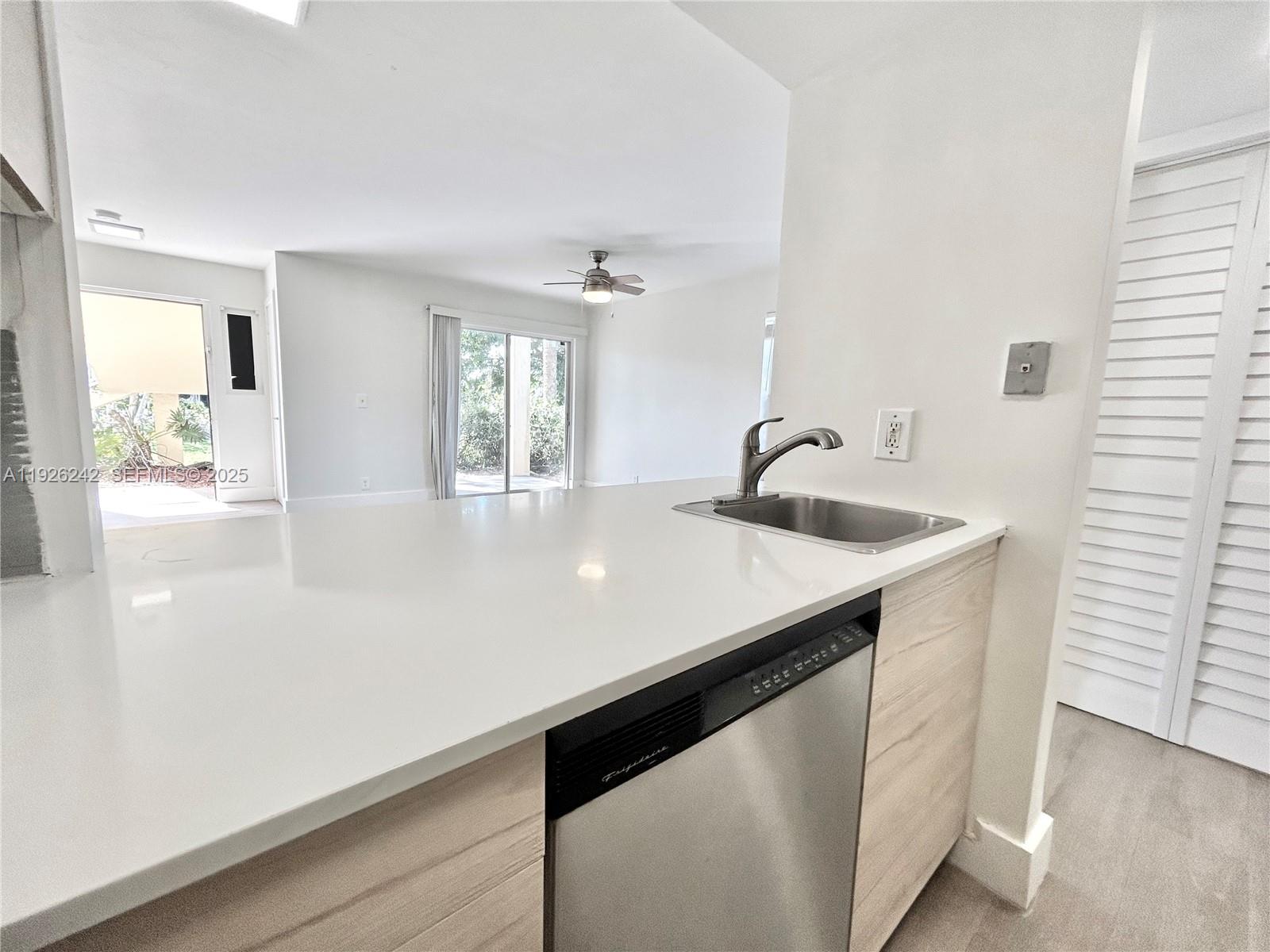 6340 La Costa Drive, Unit A Boca Raton, FL 33433 - Photo 12 of 28 a kitchen with stainless steel appliances a sink and a window