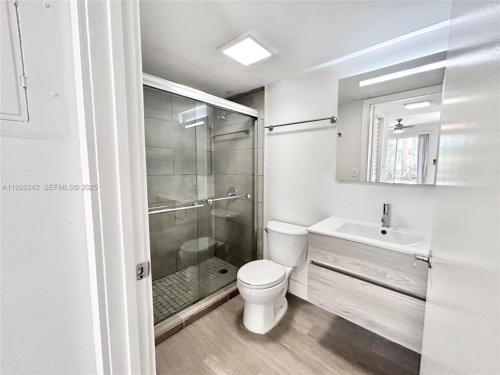 6340 La Costa Drive, Unit A Boca Raton, FL 33433 - Photo 14 of 28 a bathroom with a sink toilet a mirror and shower