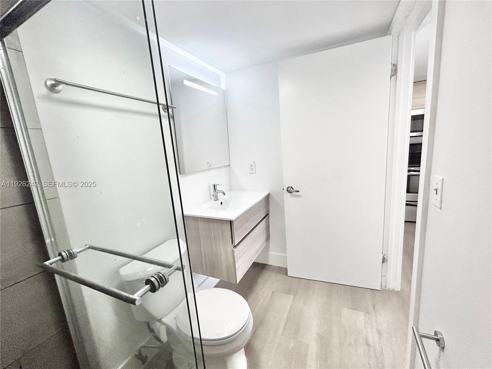 6340 La Costa Drive, Unit A Boca Raton, FL 33433 - Photo 16 of 28 a white toilet sitting next to a bathroom sink