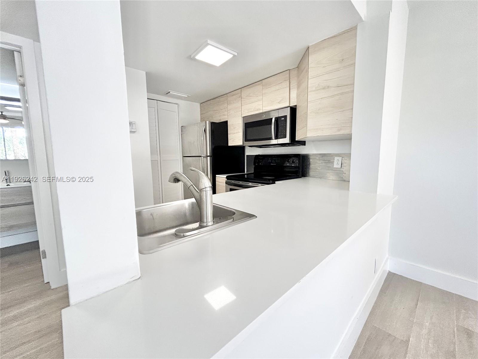 6340 La Costa Drive, Unit A Boca Raton, FL 33433 - Photo 6 of 28 a living room with furniture and a flat screen tv