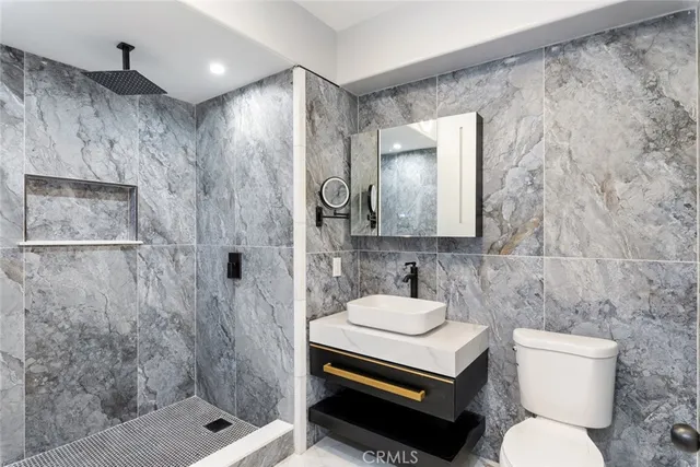 a bathroom with a sink toilet and shower