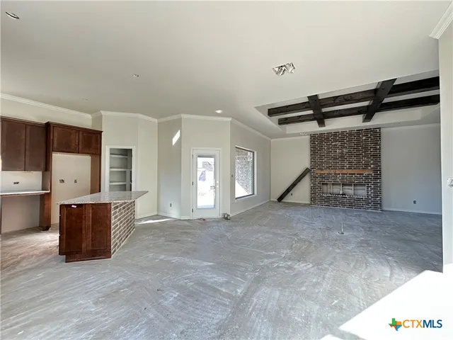 a view of an empty room with kitchen