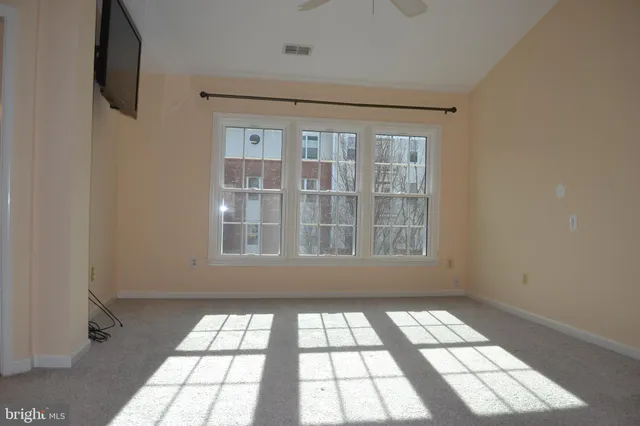 a view of an empty room and a window