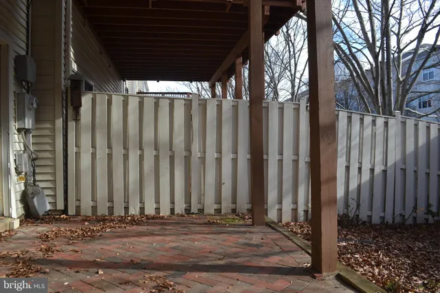 a street sign on a sidewalk next to a road
