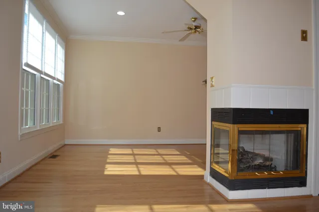 a room with a fireplace and a wooden floor