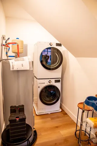 a bedroom with a bed and a flat tv screen on dresser