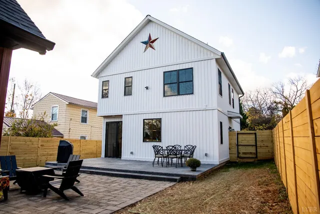 a living room with furniture and a kitchen view