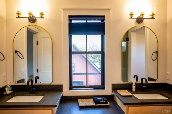 a bathroom with a double vanity sink and a mirror
