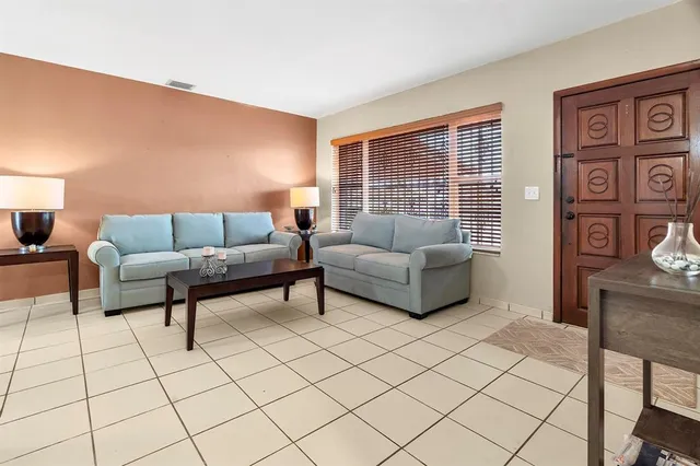 a living room with furniture and white walls