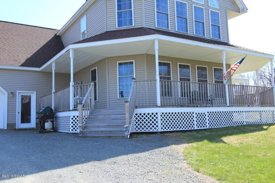 176 Highland Road Pleasant Mount, PA 18453 - Photo 7 of 52 a front view of a house with a garden
